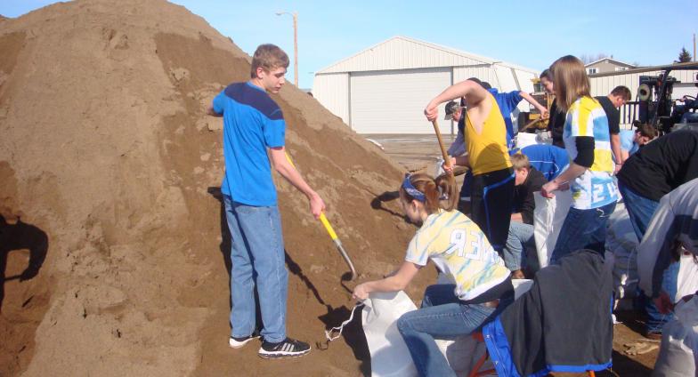 youth filling sandbags