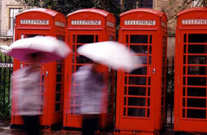 Photo of Cambridge telephone booths in the rain.