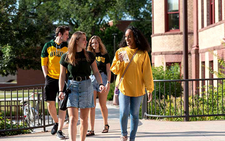 NDSU students walking on campus on a sunny day
