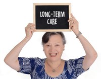 Older Person holding a sign that reads "Long-term Care"