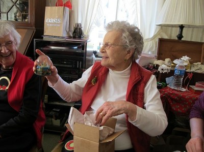 An older woman opens a present
