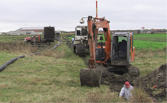 A lot of equipment is required to install tile drainage.