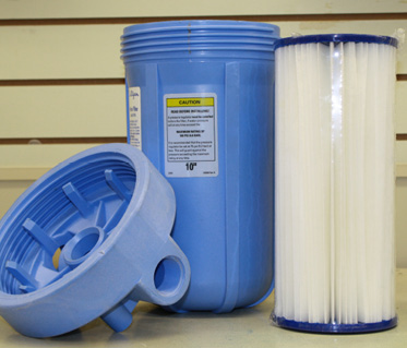 blue water filter casing with pleated filter to the right of it