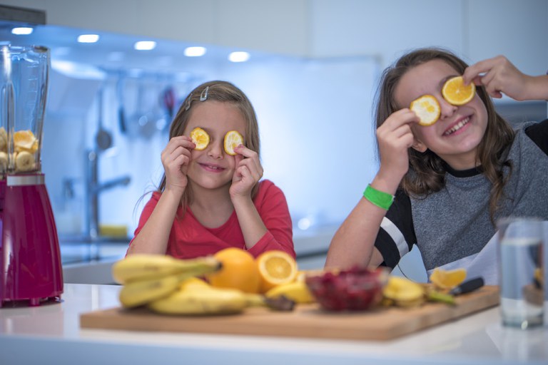school kids using lemon slices as eyes