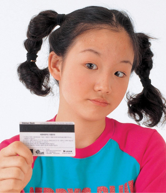 Young girl holding credit card