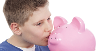 Boy kissing a pink piggy bank