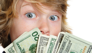 young child peeking out from behind fan of dollar bills
