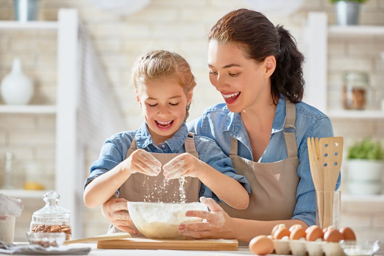 Girl and woman mixing dough
