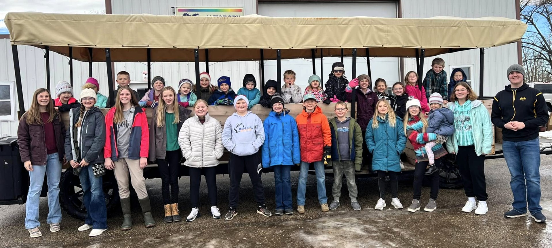 Logan County 4-H club members standing in front of the caroling wagon.