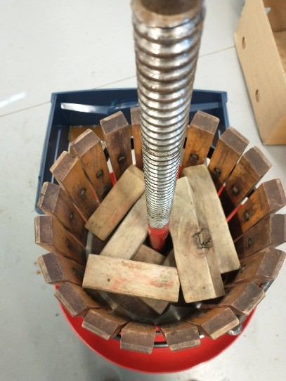 Unsecured wood blocks tumbled inside the fruit press.
