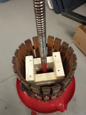Secured blocks on fruit press.