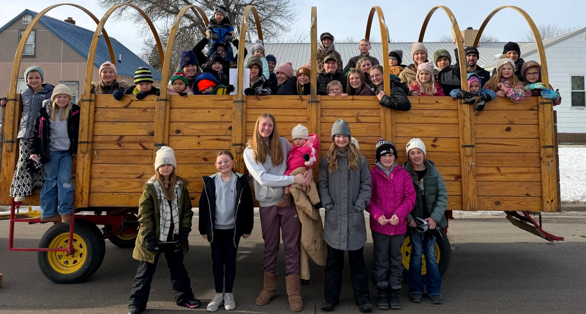 Logan County 4-H carolers standing in front of buggy