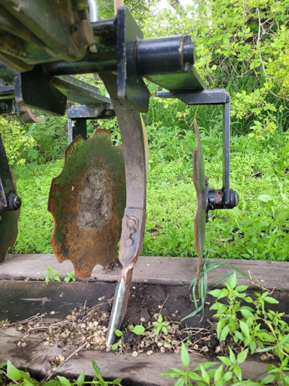 Figure 28.9 Ammonia applicator using adapted ammonia knives on chisel plow shanks, with rolling discs behind to cover the trench. NDSU image
