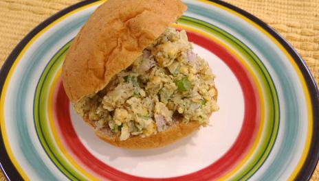 photograph of a chickpea salad sandwich on a colorful plate