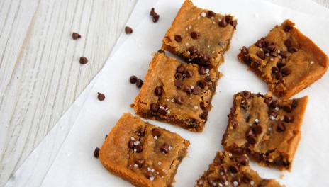photograph of chocolate chip chickpea blondies on a white serving platter