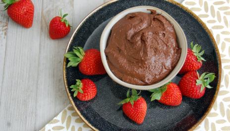 Chocolate Dessert Hummus, served in a dish with strawberries nearby