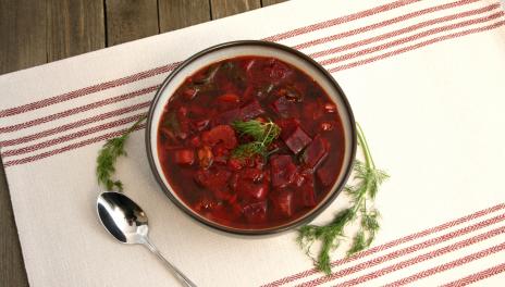 dark red German-Russian Borscht Soup, prepared and served in a bowl with a spoon