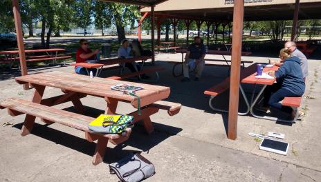 group of people sitting at picnic tables