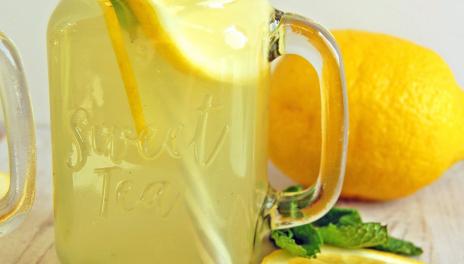 Mint Lemonade, prepared and served in a glass jar with slices of lemon