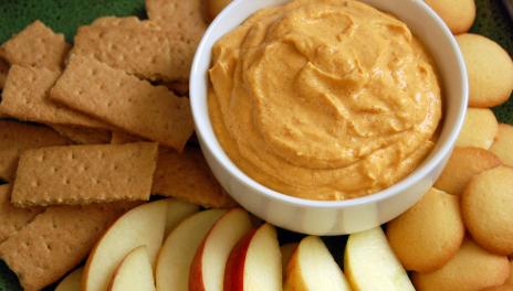 Pumpkin Spice Yogurt Dip, served in a dish, surrounded by apple slices and graham crackers
