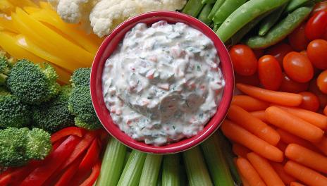 Spinach and Kale Greek Yogurt Dip, prepared and served in a bowl surrounded by veggies