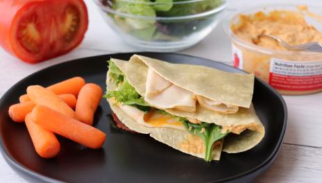 Tortilla wrap on plate with carrots