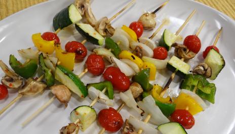 photograph of vegetable kabobs on a white plate