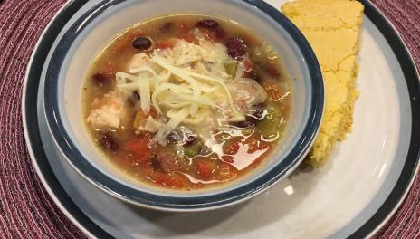Mexican Fiesta Chicken Soup, served with a slice of cornbread