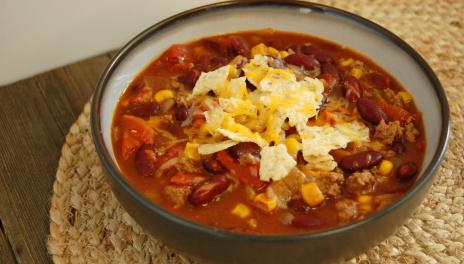 Slow Cooker Taco Soup, served with cheese and chips