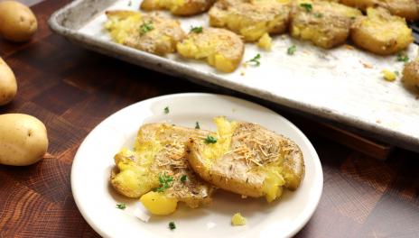 garlic smashed potatoes on a plate 