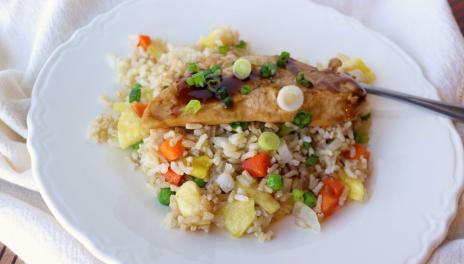 plate with fried rice and teriyaki chicken tenderloin and fork