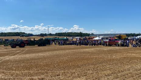 North American Manure Expo attendees lined up to watch side-by-side comparisons of solid (foreground) and liquid (background, center) manure spreading equipment.