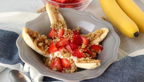 bowl with sliced banana, strawberries and yogurt