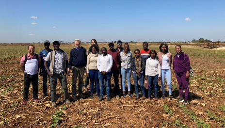 Juan Osorno and resesearch tems in a field in Zambia, S. Africa