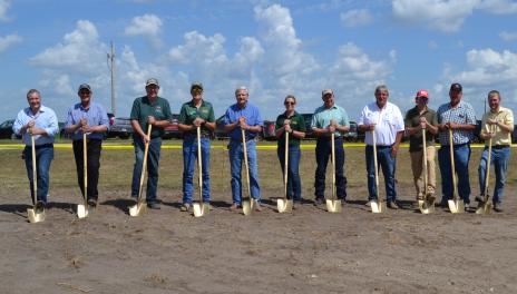 Several people with shovels at a groundbreaking ceremony. 