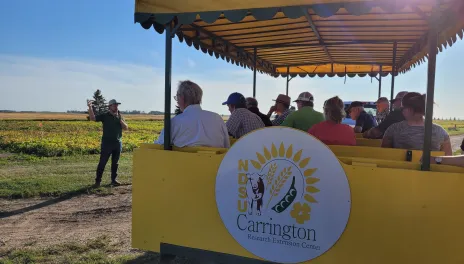 A speaker gestures at a field. 
