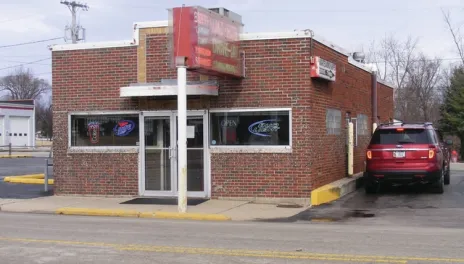 A non-descript small, one-story brick building with a drive-through pick up window.
