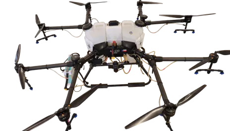 A spray drone with eight propellors and sixteen spray tips carries a tank for pesticides.