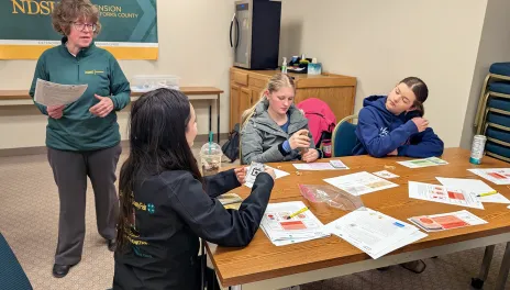 a woman teaching teens 4-H material