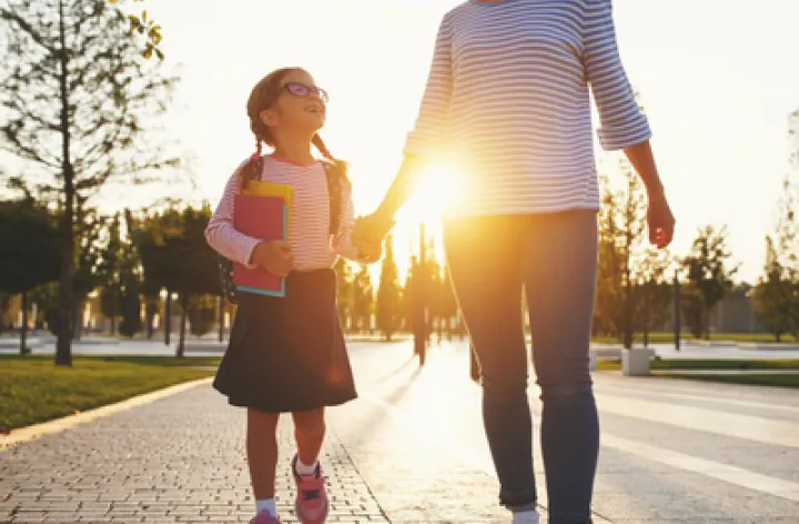 Mother and daughter walking hand-in-hand