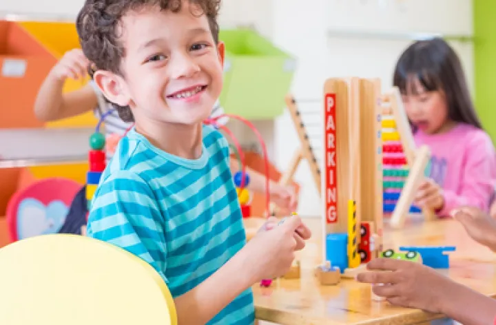 A young boy plays in a kindergarten class