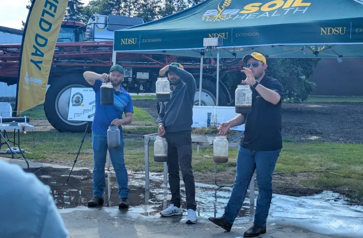 men doing a water demo for soil health