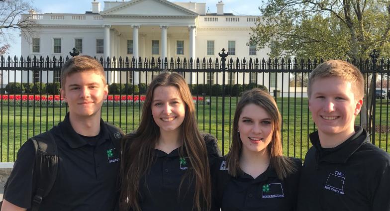 4 youth in front of white house