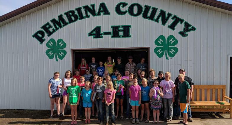 4-H youth standing in front of building Pembina County 4-H