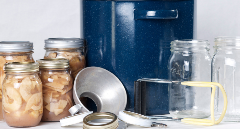 jars of canned fruit slices with water bath canner and canning equpment