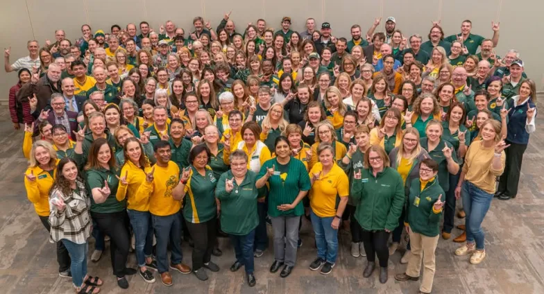 A large group of people giving wearing either NDSU green or gold
