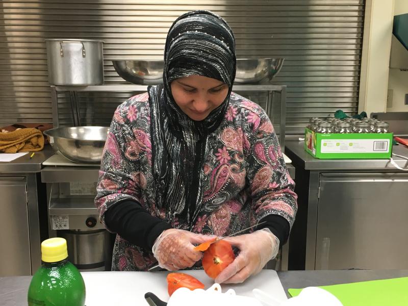woman slicing tomato