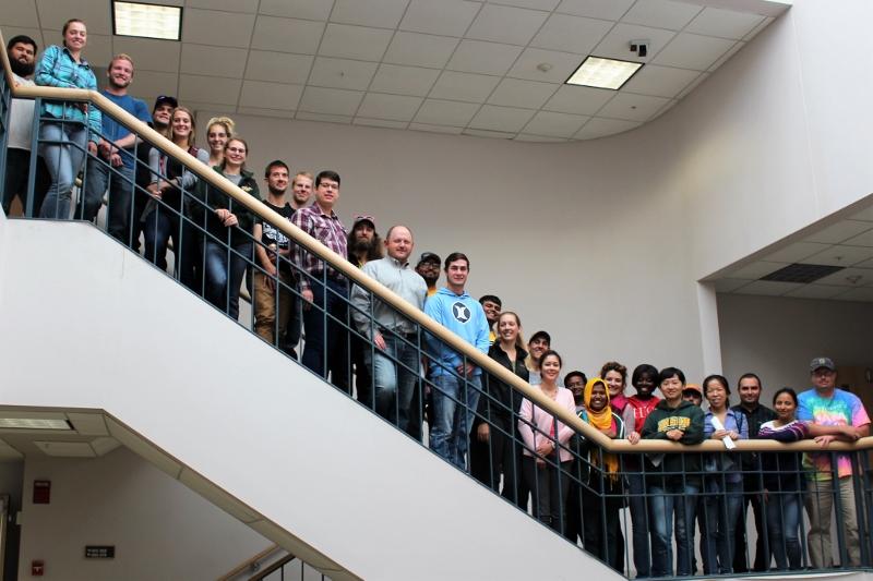 students posing on a staircase