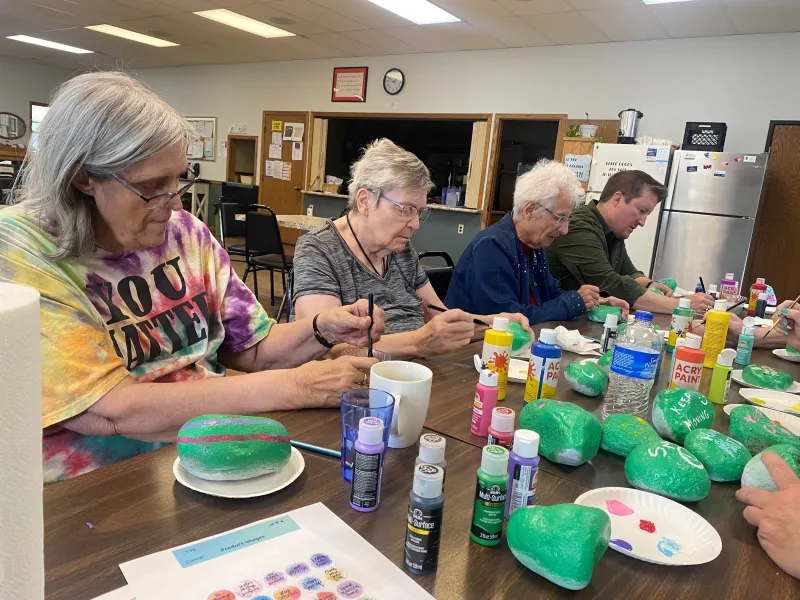 women painting rocks