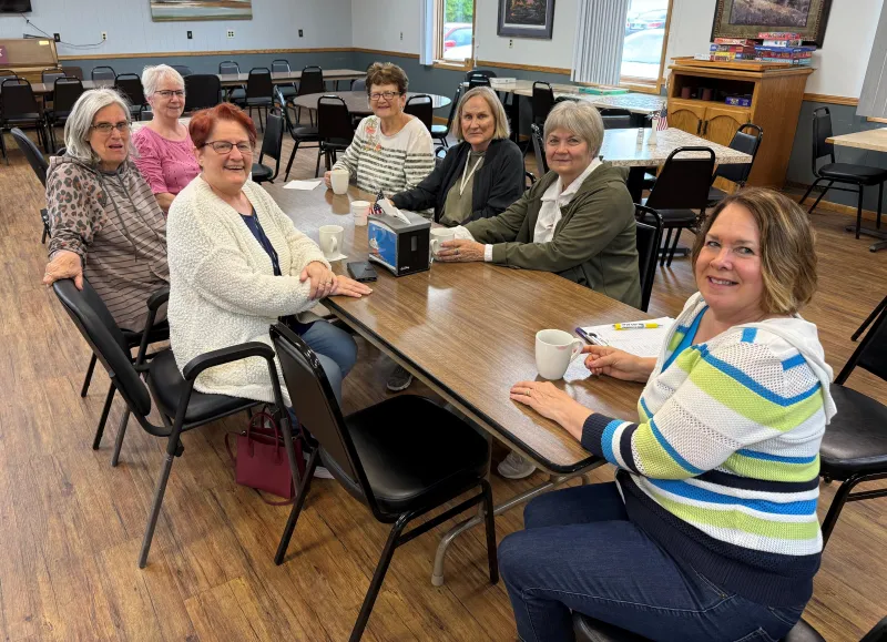 ladies at a table posing for the camera